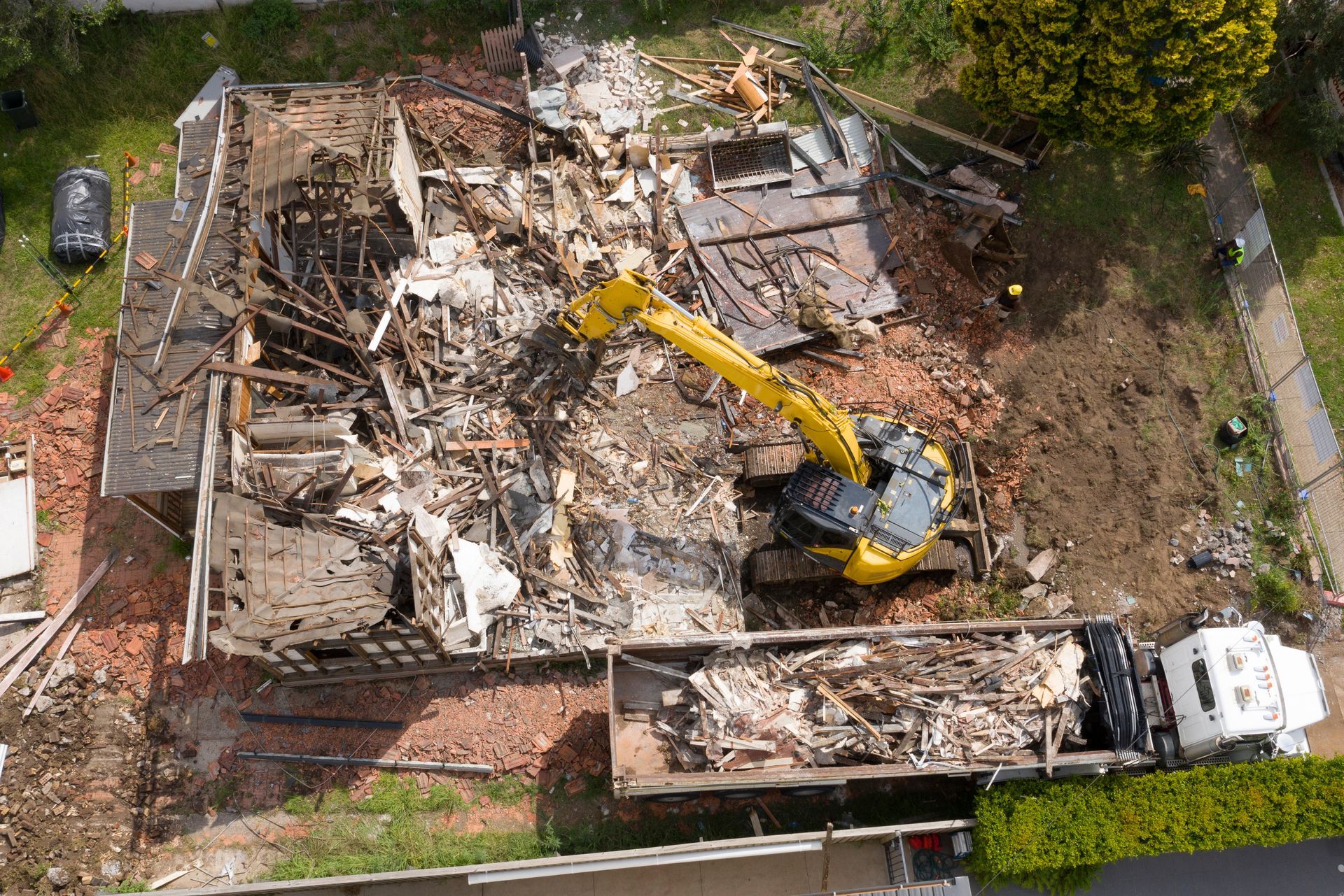 An aerial view of a house being demolished.
