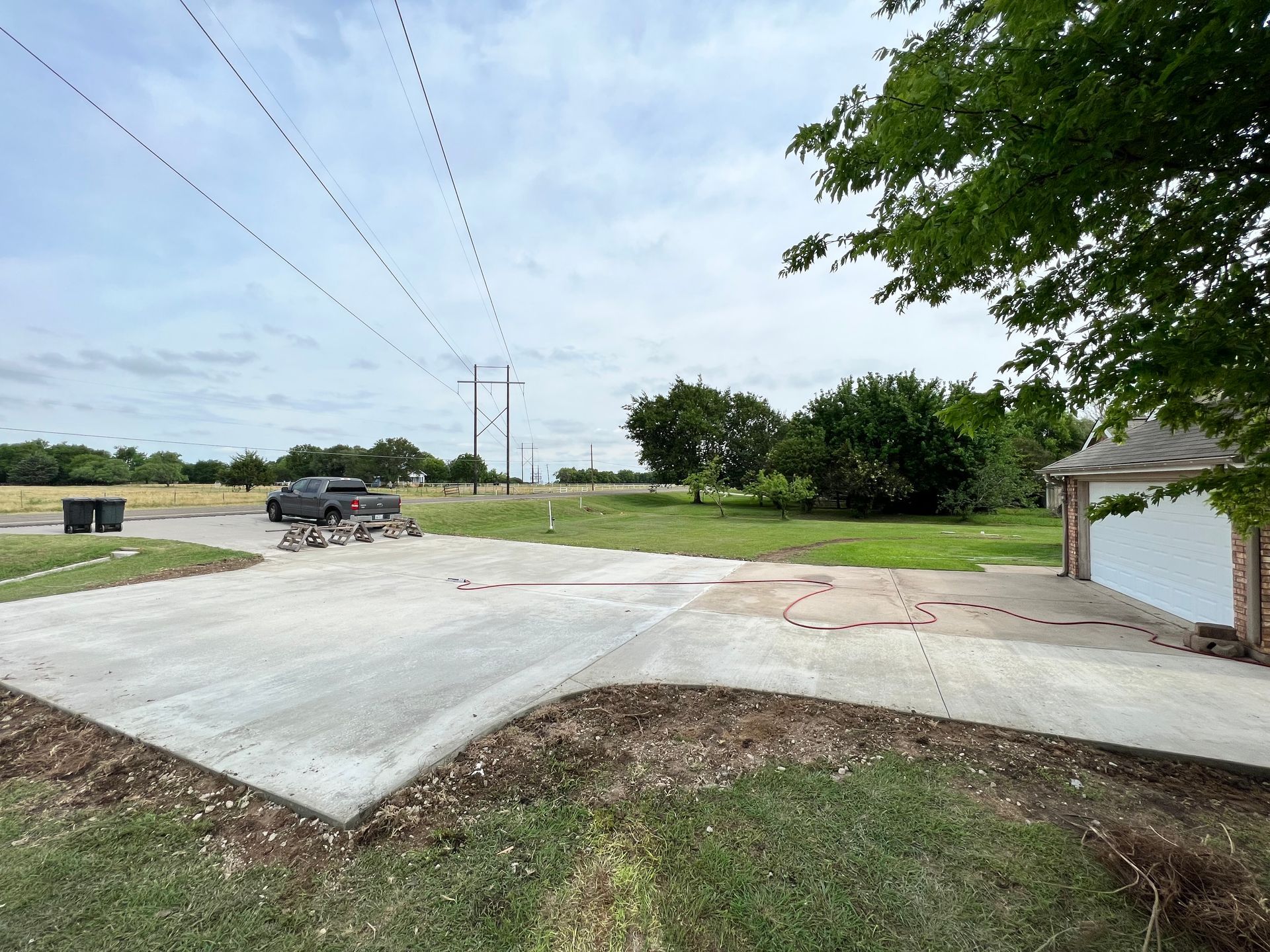 A concrete driveway is being built in front of a house.