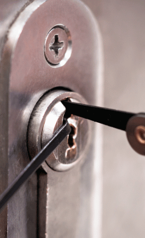Lock being picked with two black lock picks, silver lock and door frame.