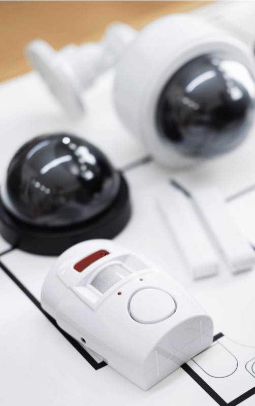 Security cameras, motion sensor, and door sensors on a diagram. White and black, modern design.