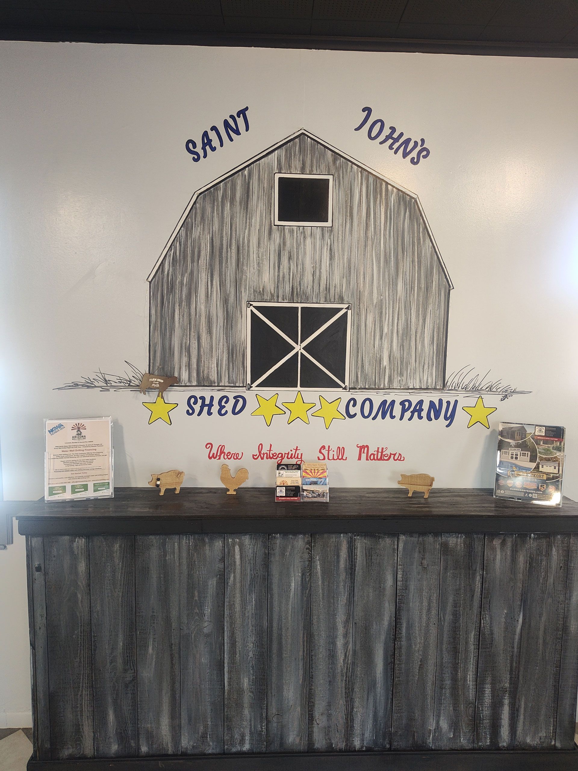 Rustic barn-style sign reading “Shuck Company” above a decorated counter display