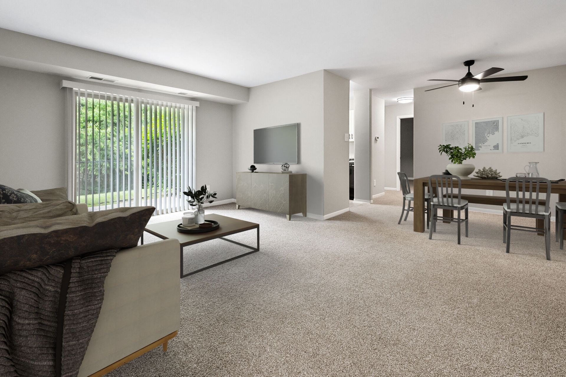 Living room in an apartment with a sofa, coffee table, TV, and a dining area near sliding doors at The Ridge Apartments in Hagerstown, MD