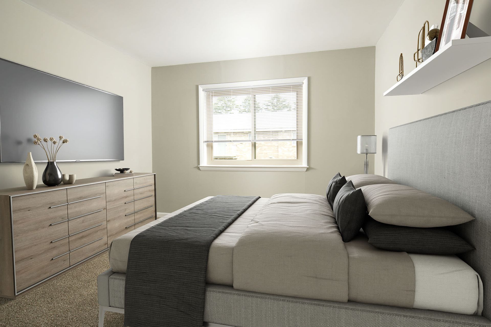 Bedroom in an apartment with a low-profile bed, gray headboard, and dresser by a window at The Ridge Apartments in Hagerstown, MD