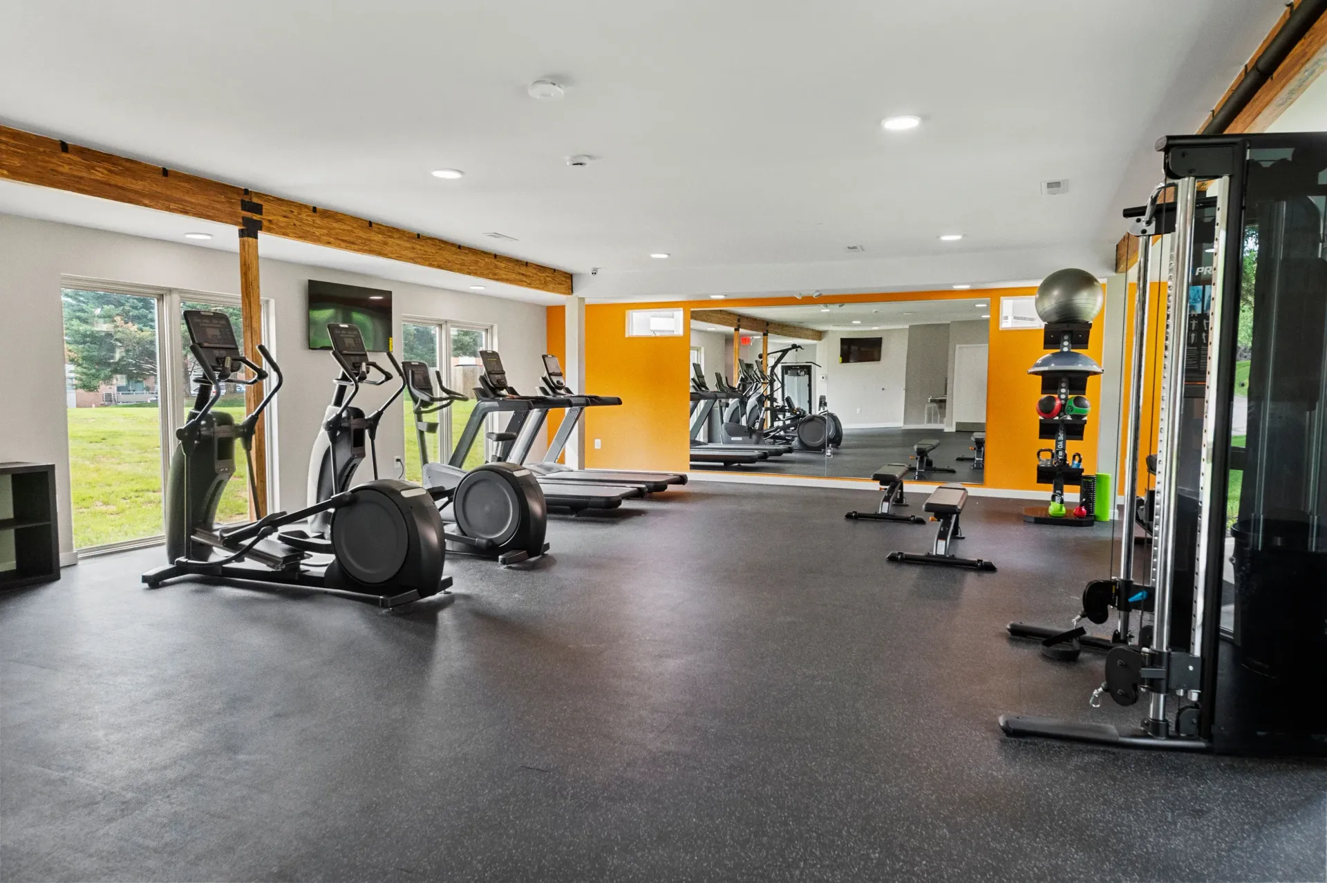 Bright community gym with cardio machines and free weights at The Ridge Apartments in Hagerstown, MD