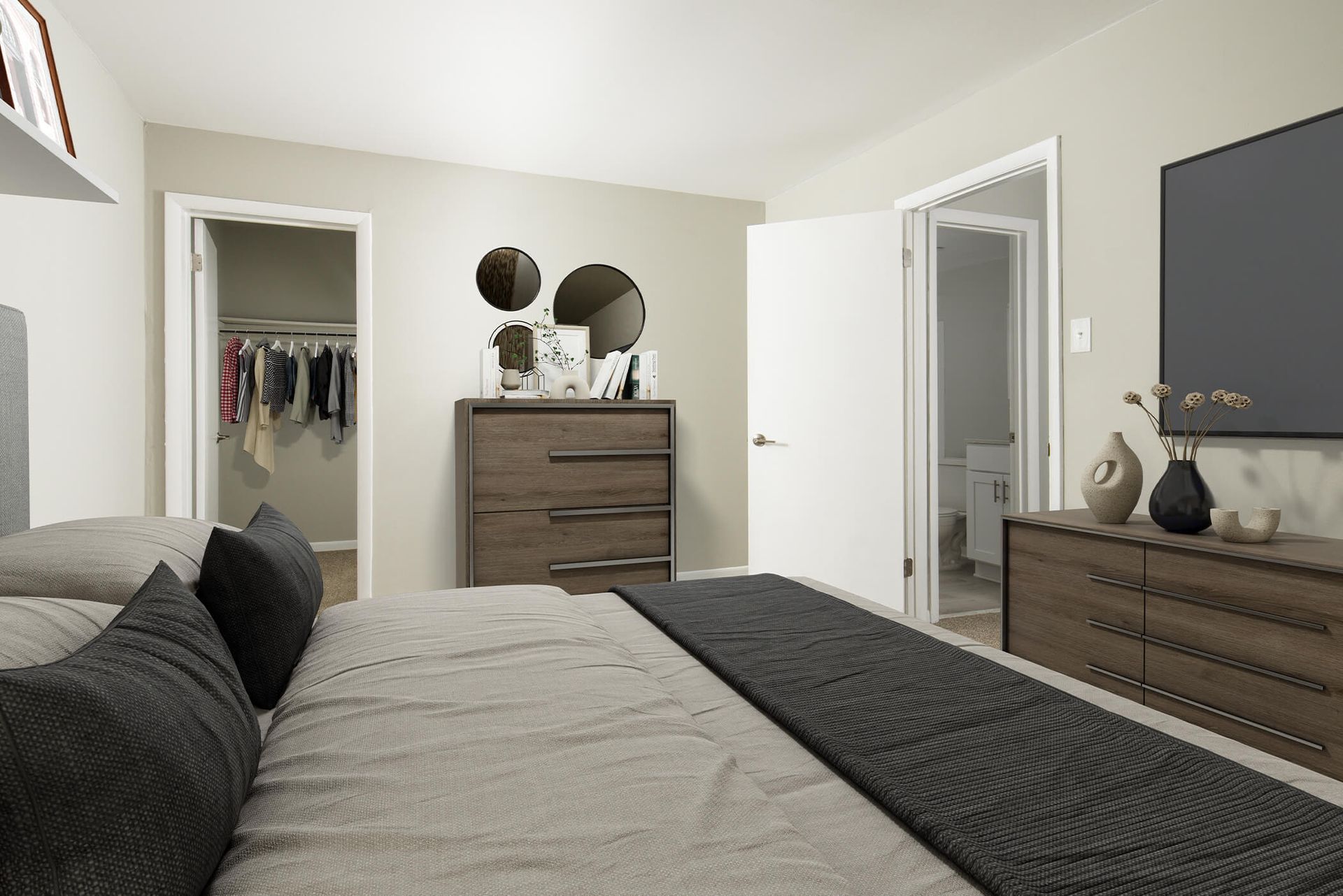 Neutral-toned bedroom with a bed, two dressers, and an open closet at The Ridge Apartments in Hagerstown, MD