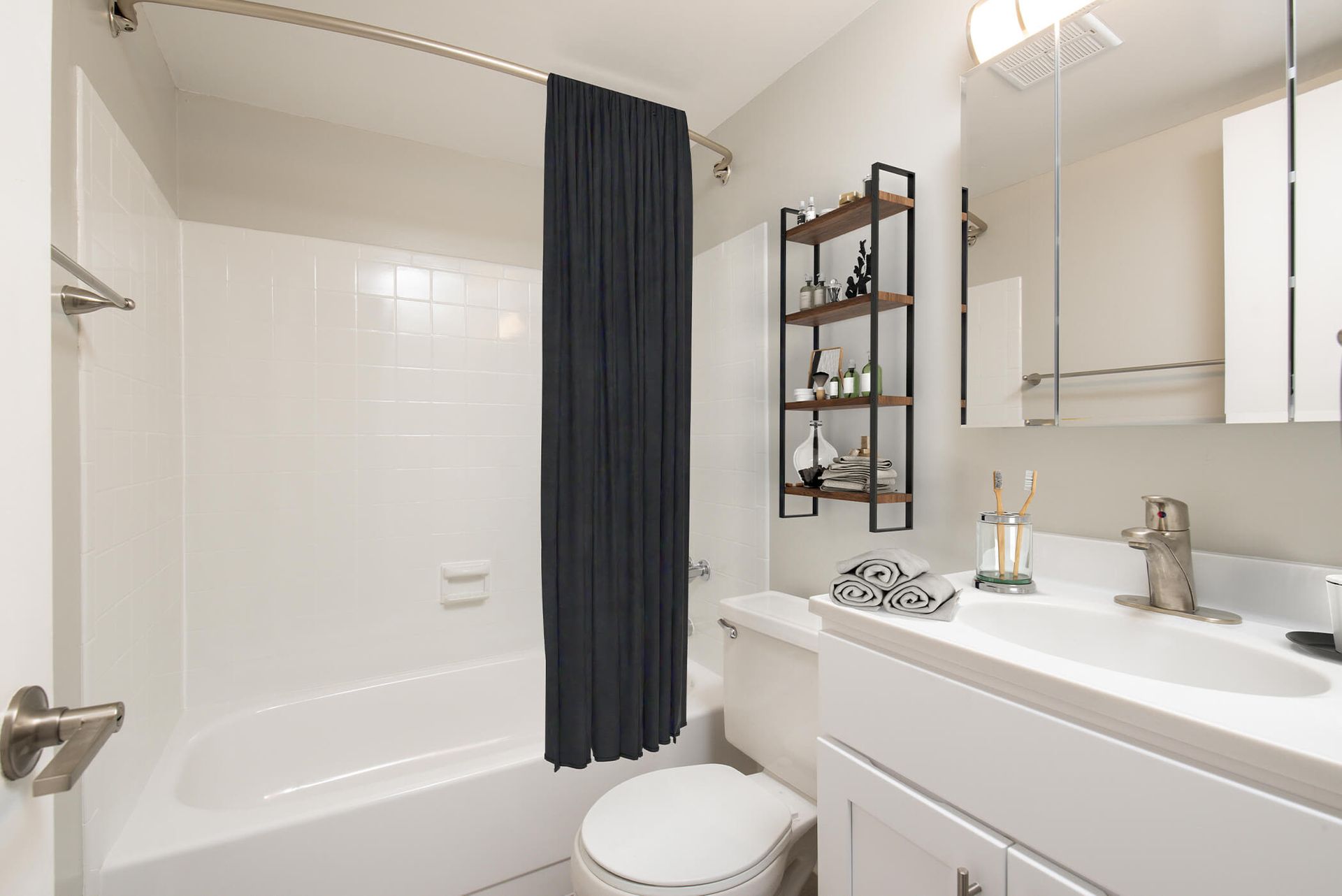 White bathroom with bathtub/shower, toilet, and white vanity at The Ridge Apartments in Hagerstown, MD