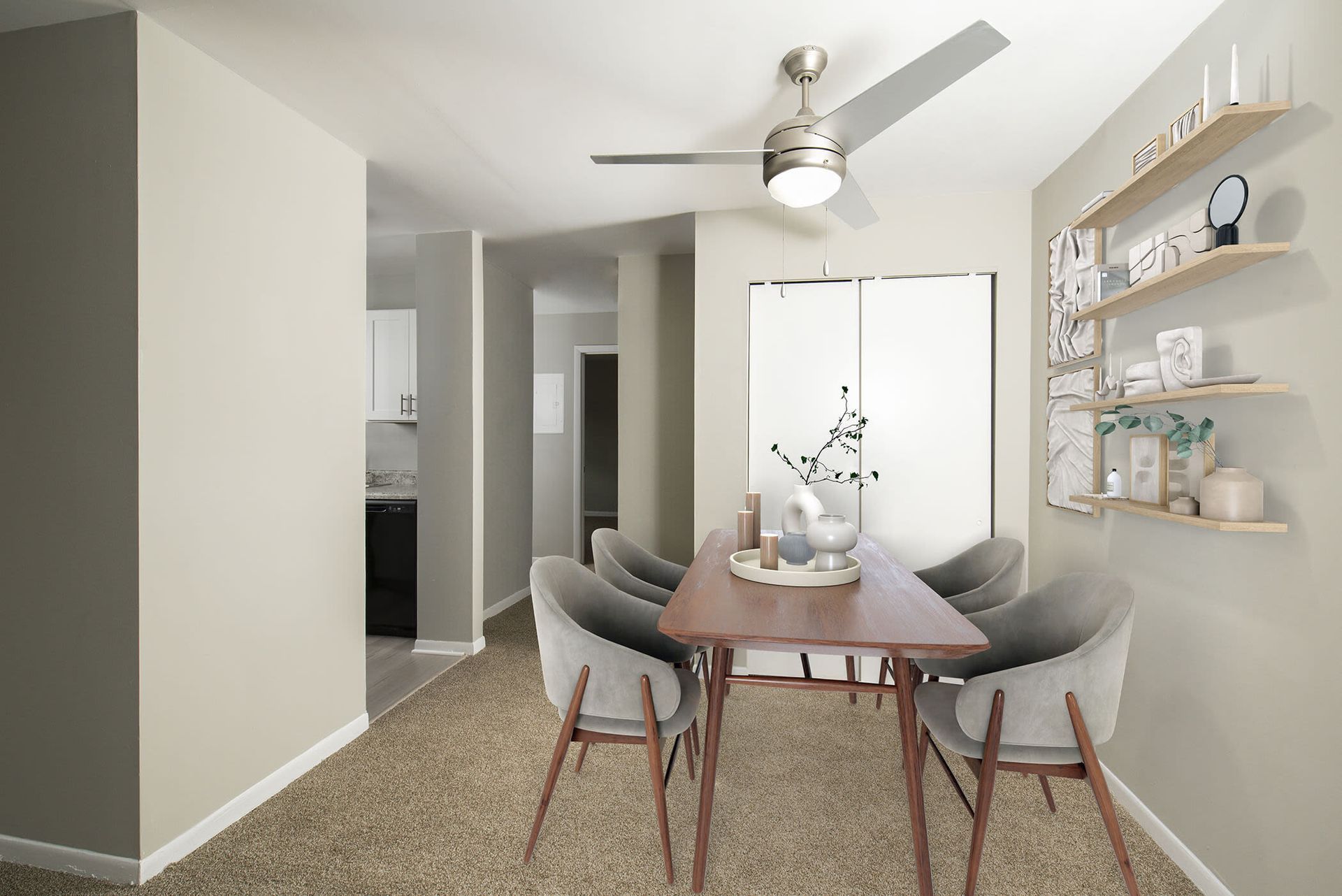 Dining area in an apartment: wooden table, four gray upholstered chairs, ceiling fan, and wall shelves at The Ridge Apartments in Hagerstown, MD
