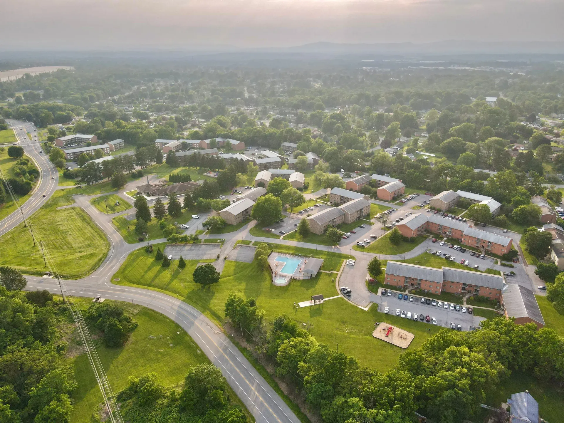 Aerial view of a large apartment community with a central pool and green lawns at The Ridge Apartments in Hagerstown, MD