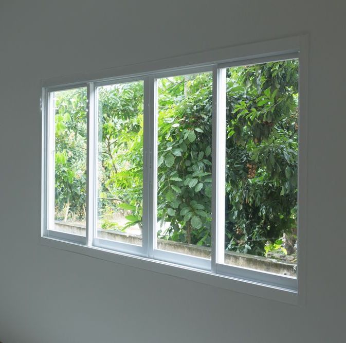 A Large Window With a Lot of Windows and Trees Behind It — Dazzling Windows & Pressure Cleaning in Burleigh Heads, QLD