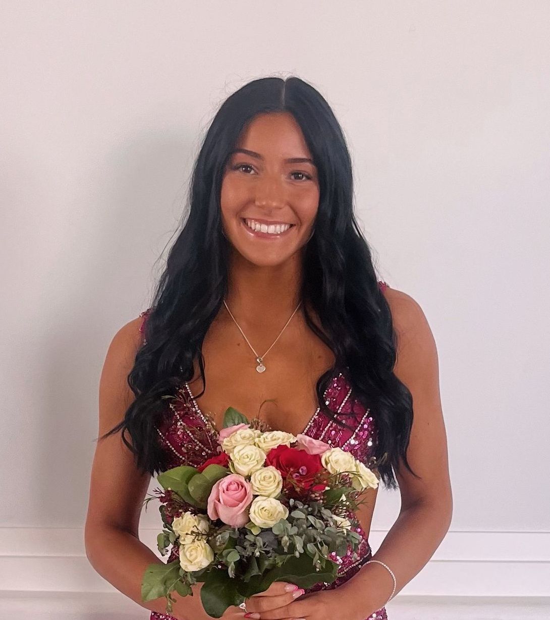 A girl wearing a pink shirt with the year 2025 on it