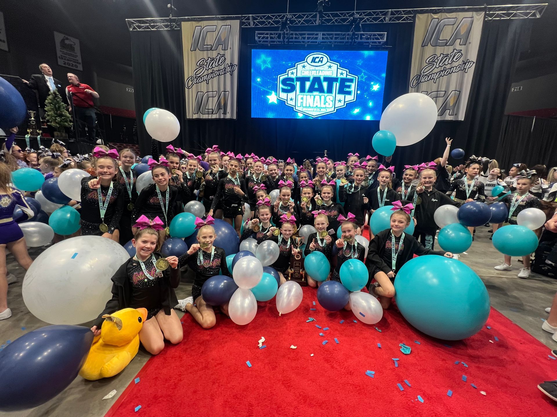 A group of cheerleaders are performing a routine in a gym.