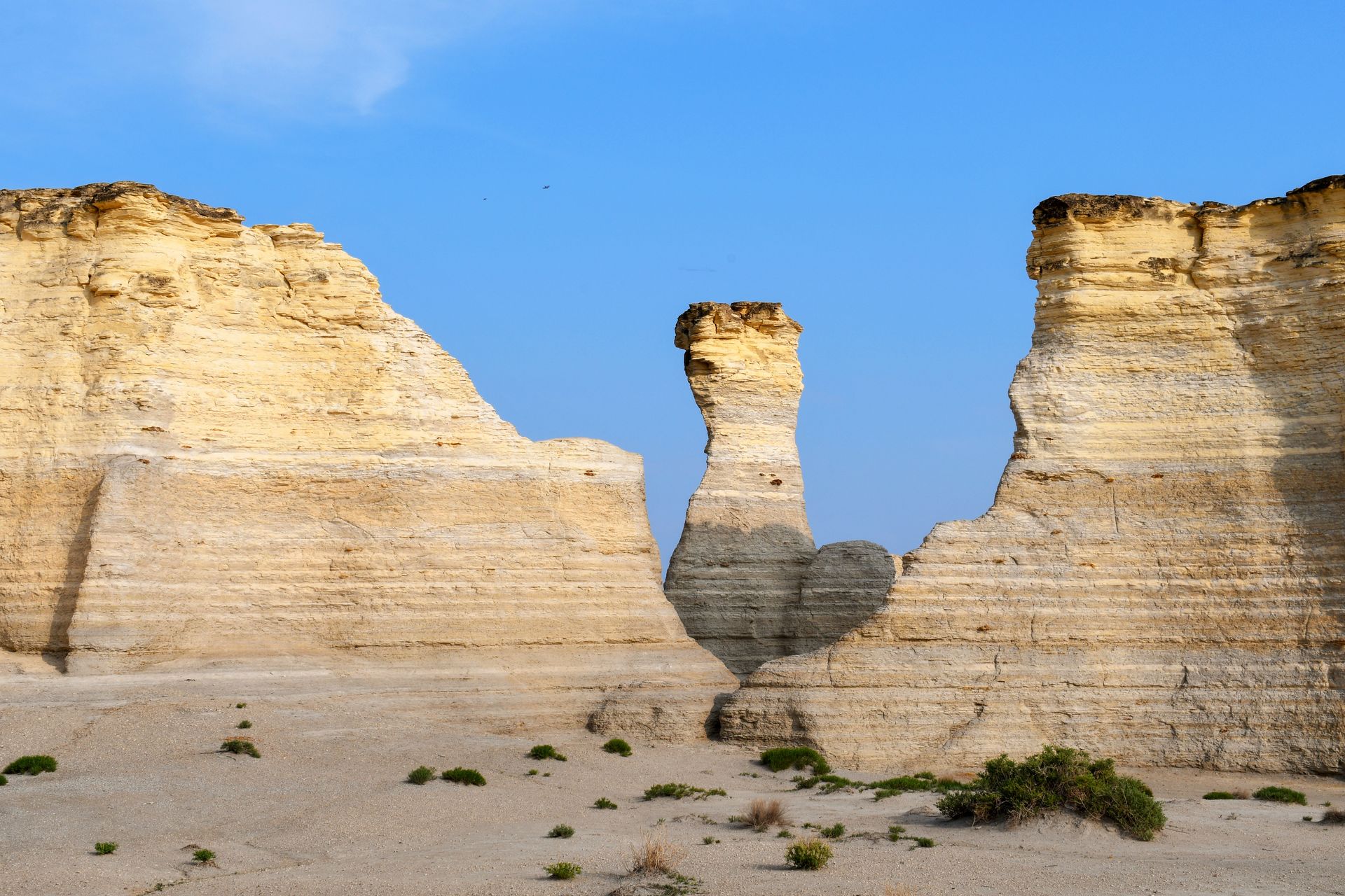 A funeral home with a black awning over the door