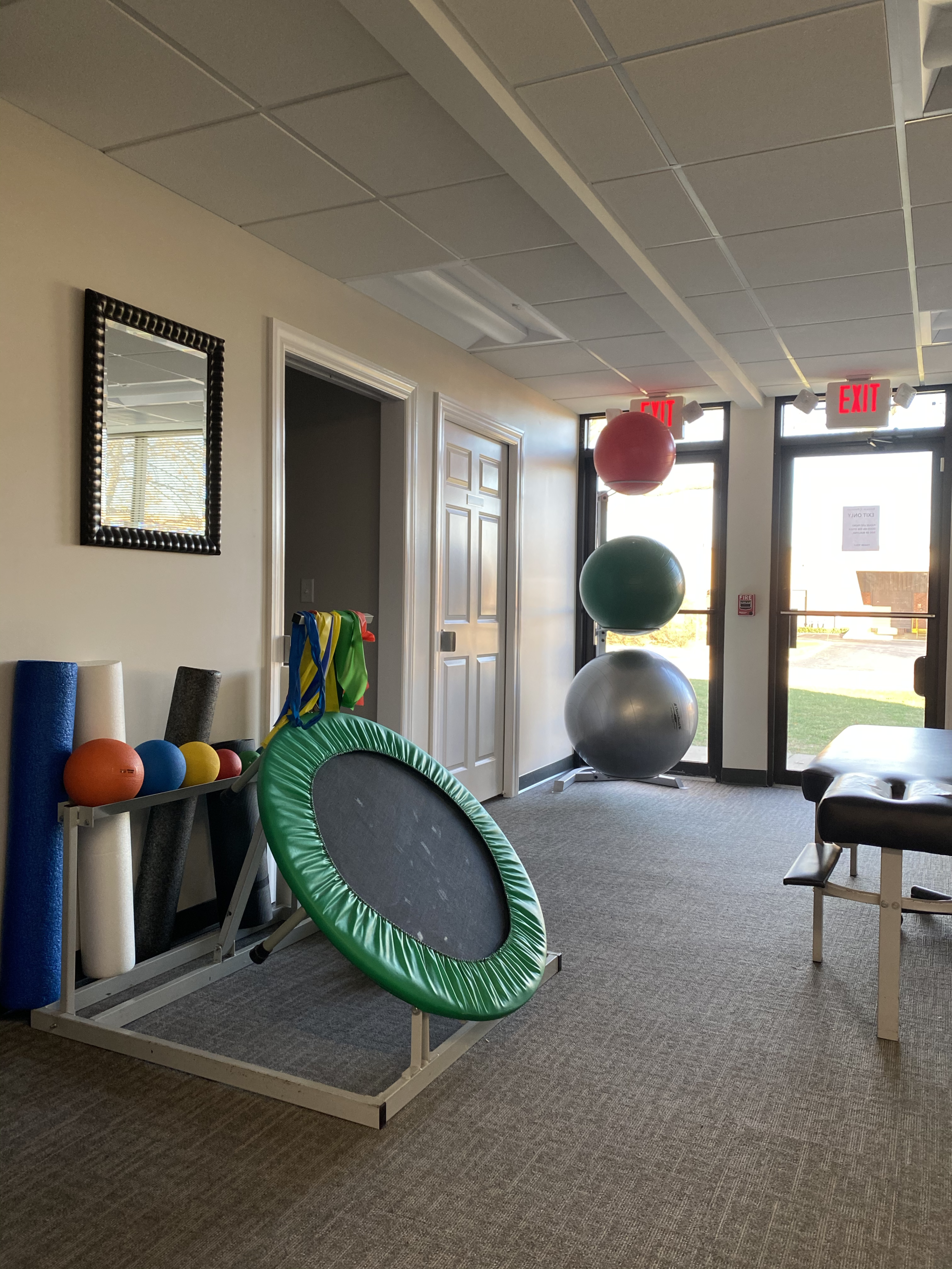 a gym with a trampoline and exercise balls