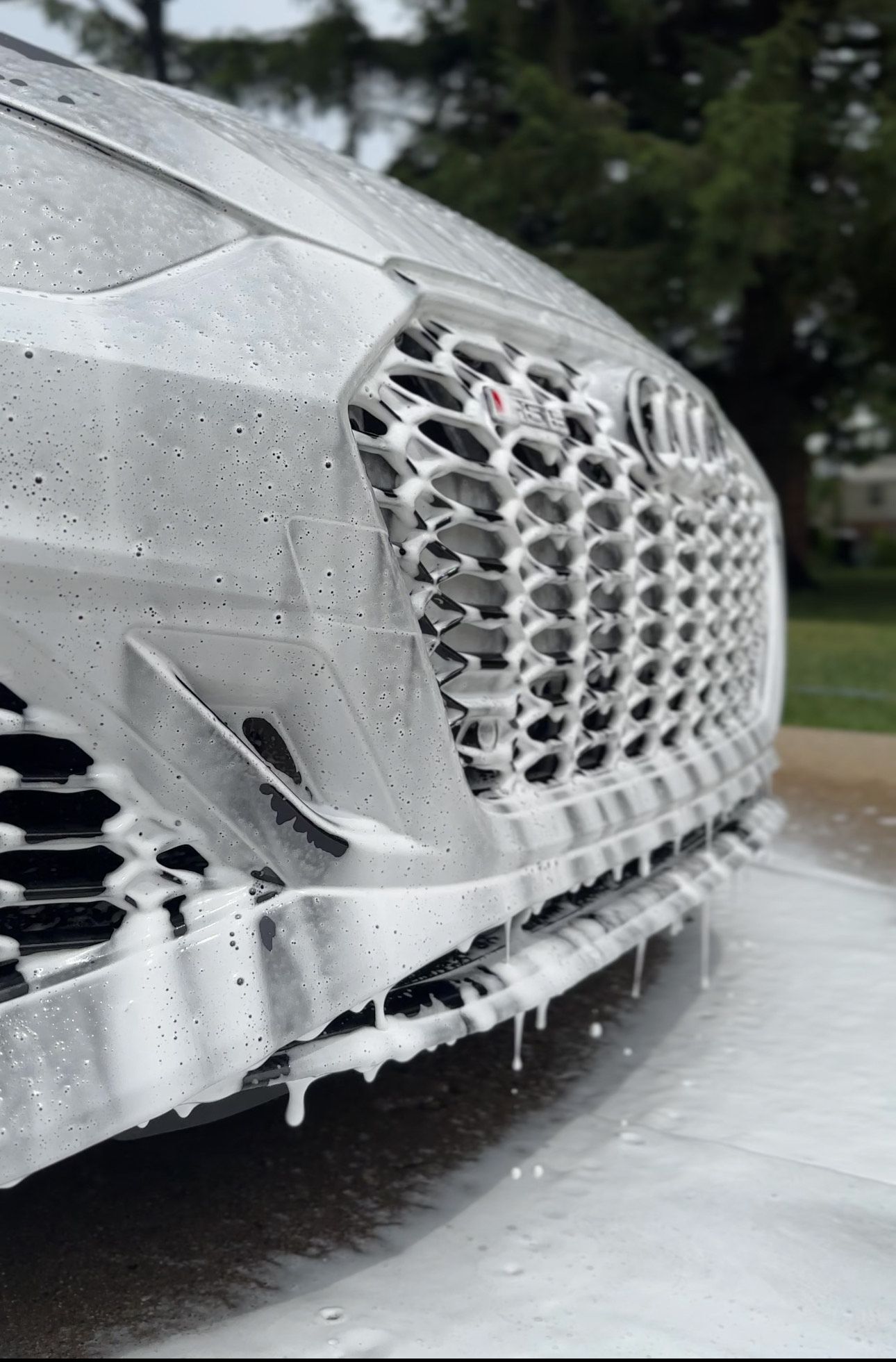 A close up of a car covered in foam.