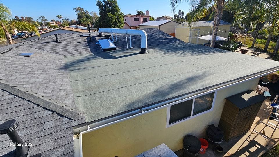 View of a residential roof with various vents, a skylight, and asphalt shingles.