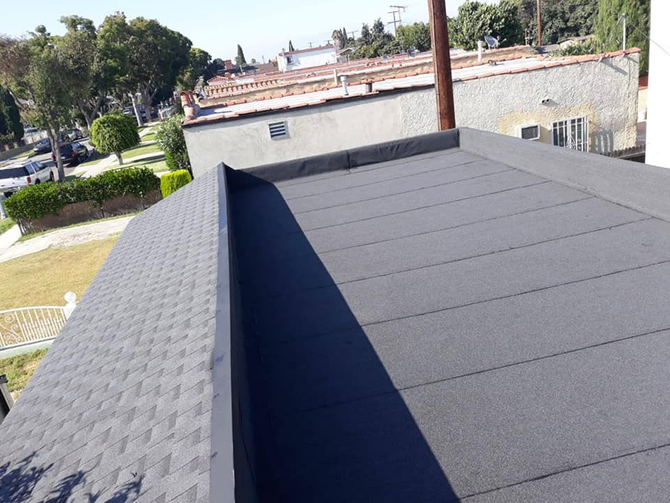 A wooden fence is sitting on top of a lush green field.