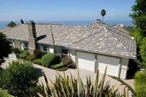 A wooden fence with a gate attached to it.