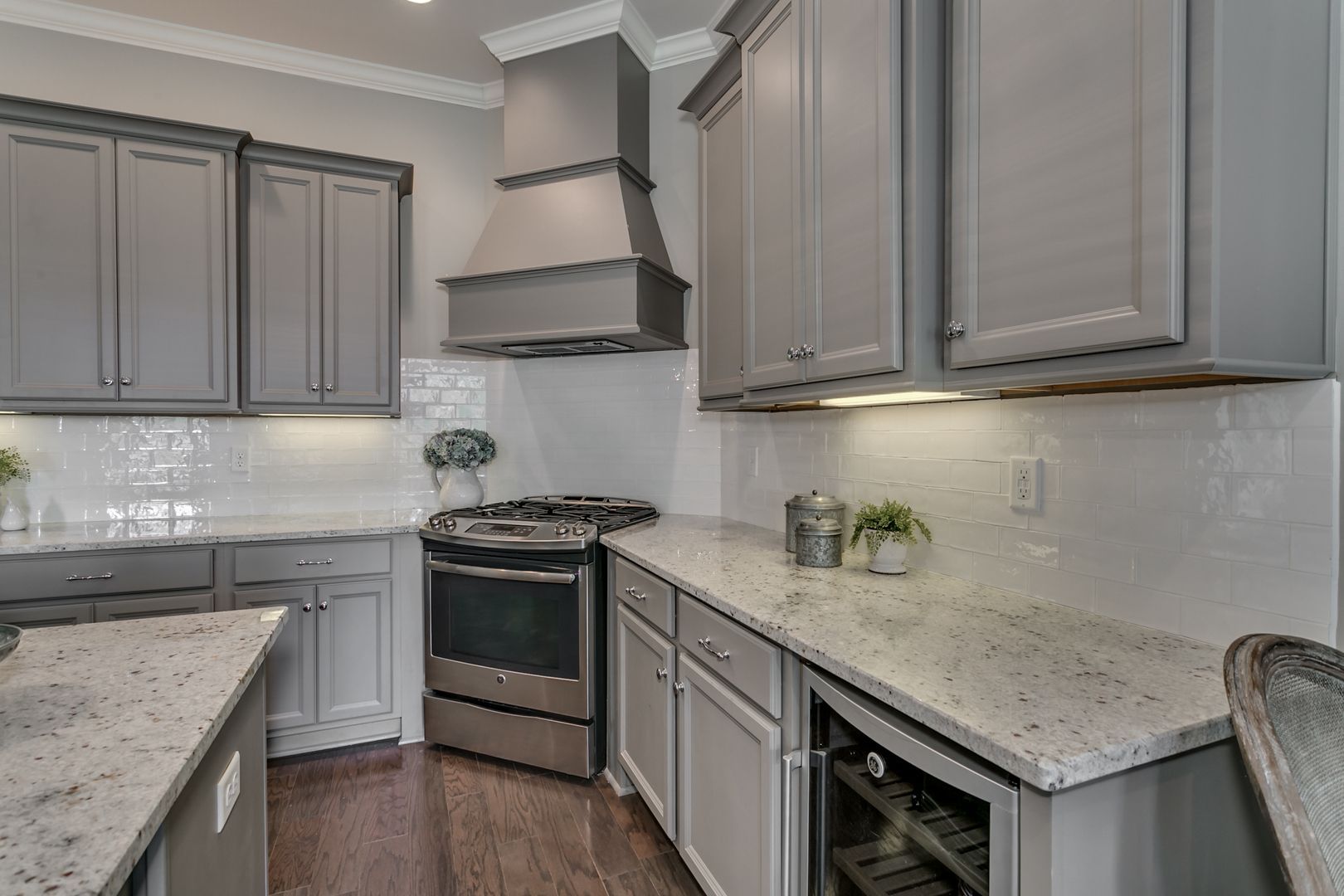 Gray kitchen with granite countertops, cabinets, and stainless steel appliances.