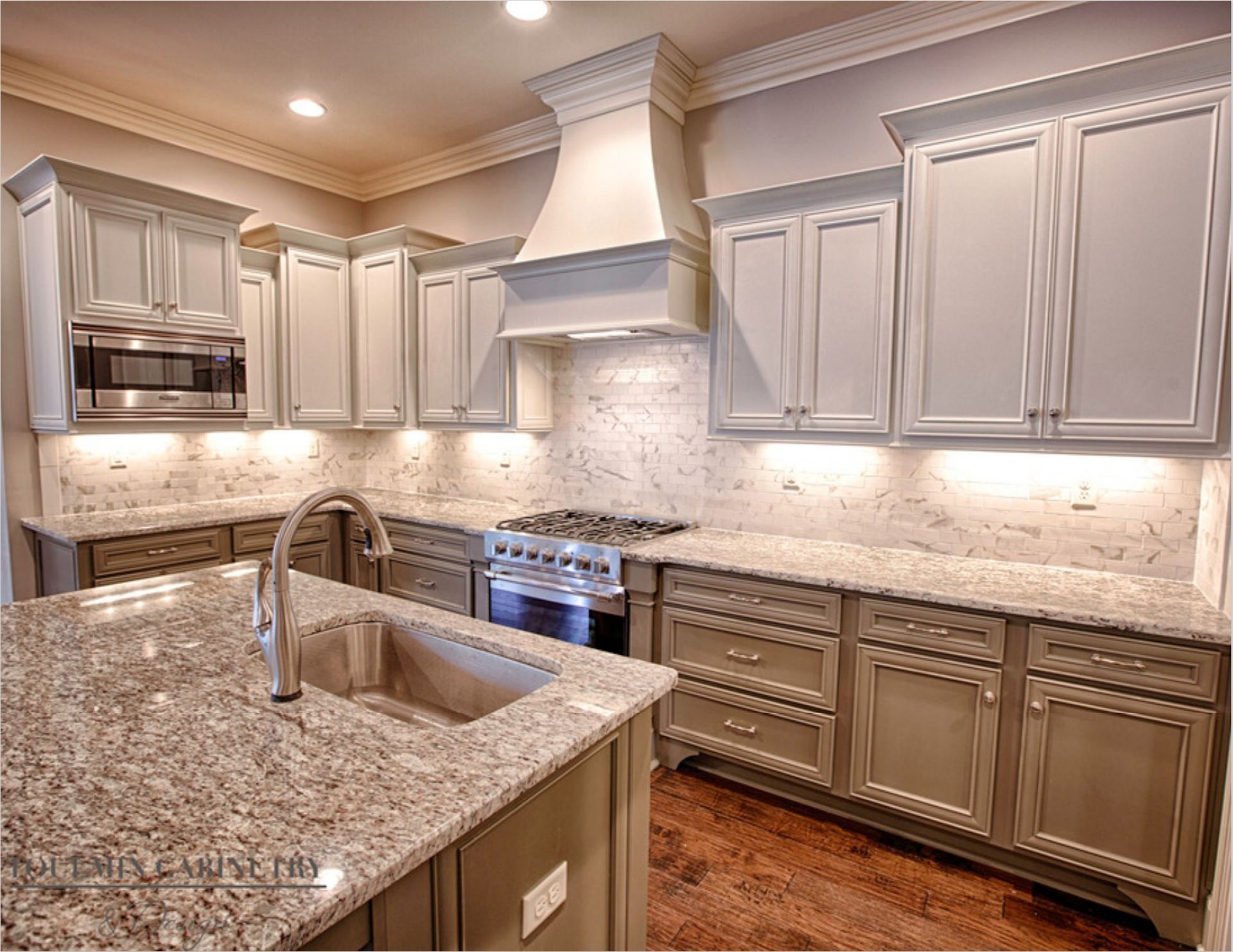 Kitchen with light gray cabinets, granite countertops, and stainless steel appliances.