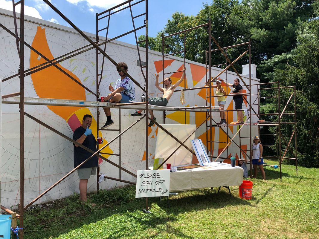 A chair with a yellow pillow and a necklace on it