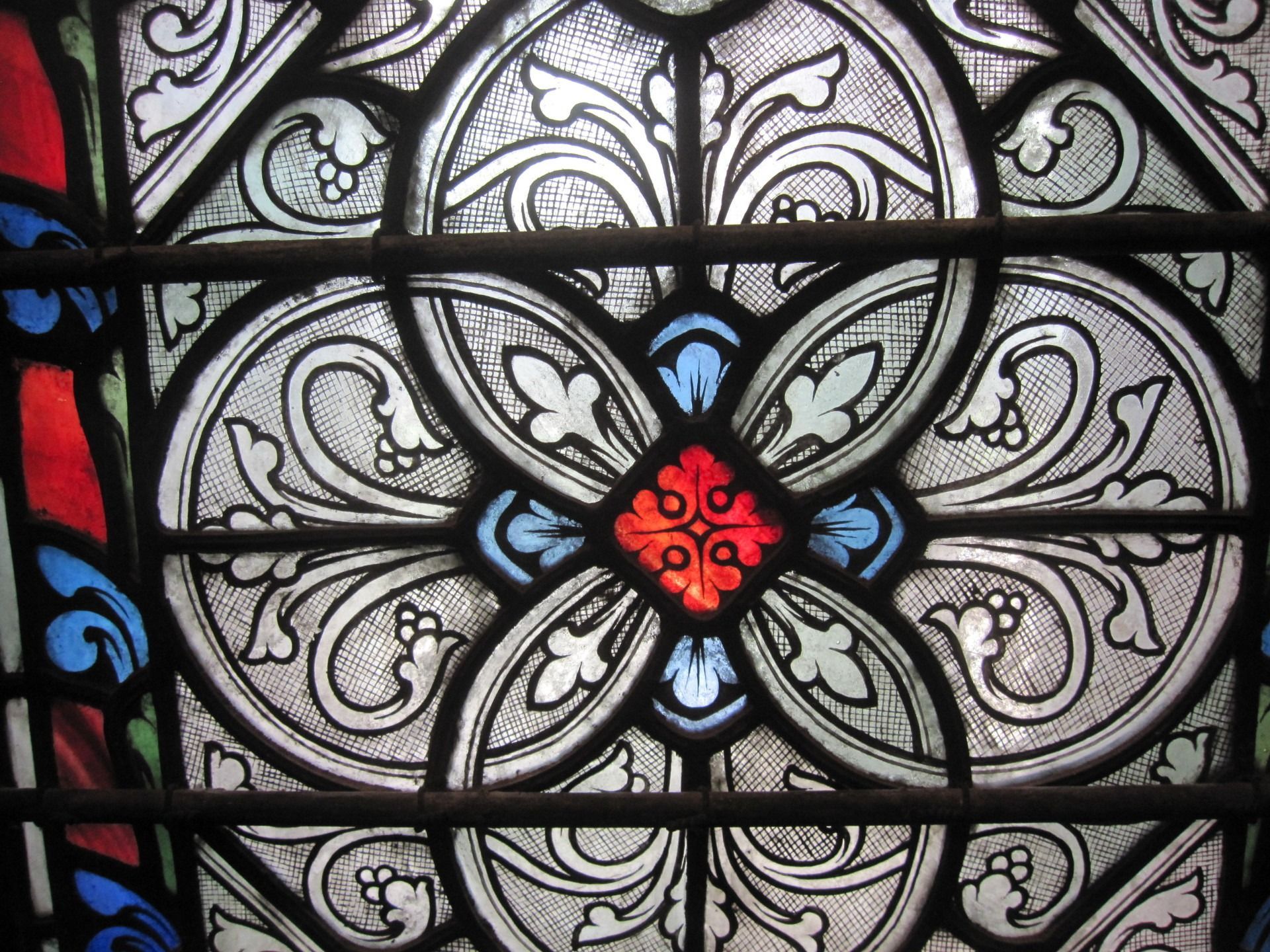 A person wearing a cow-print suit stands against a mural of a UFO beaming a cow up from a cornfield.