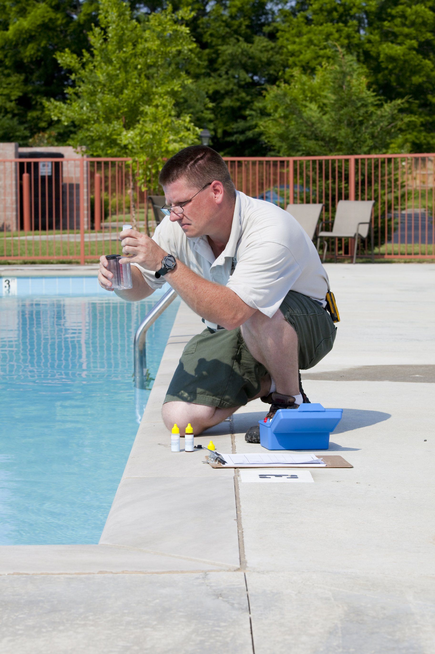 a pool service chandler technician checking a customers pool chemical levels