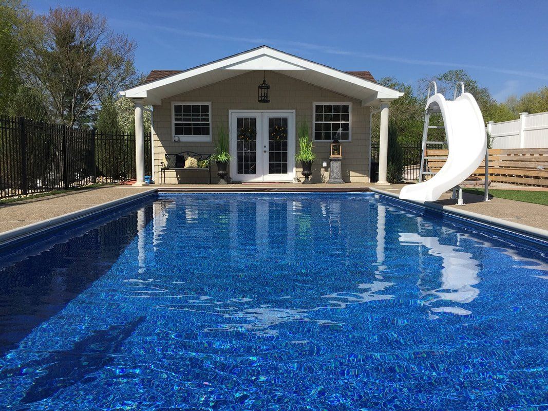 a pool house with a swimming pool and waterslide in Arizona