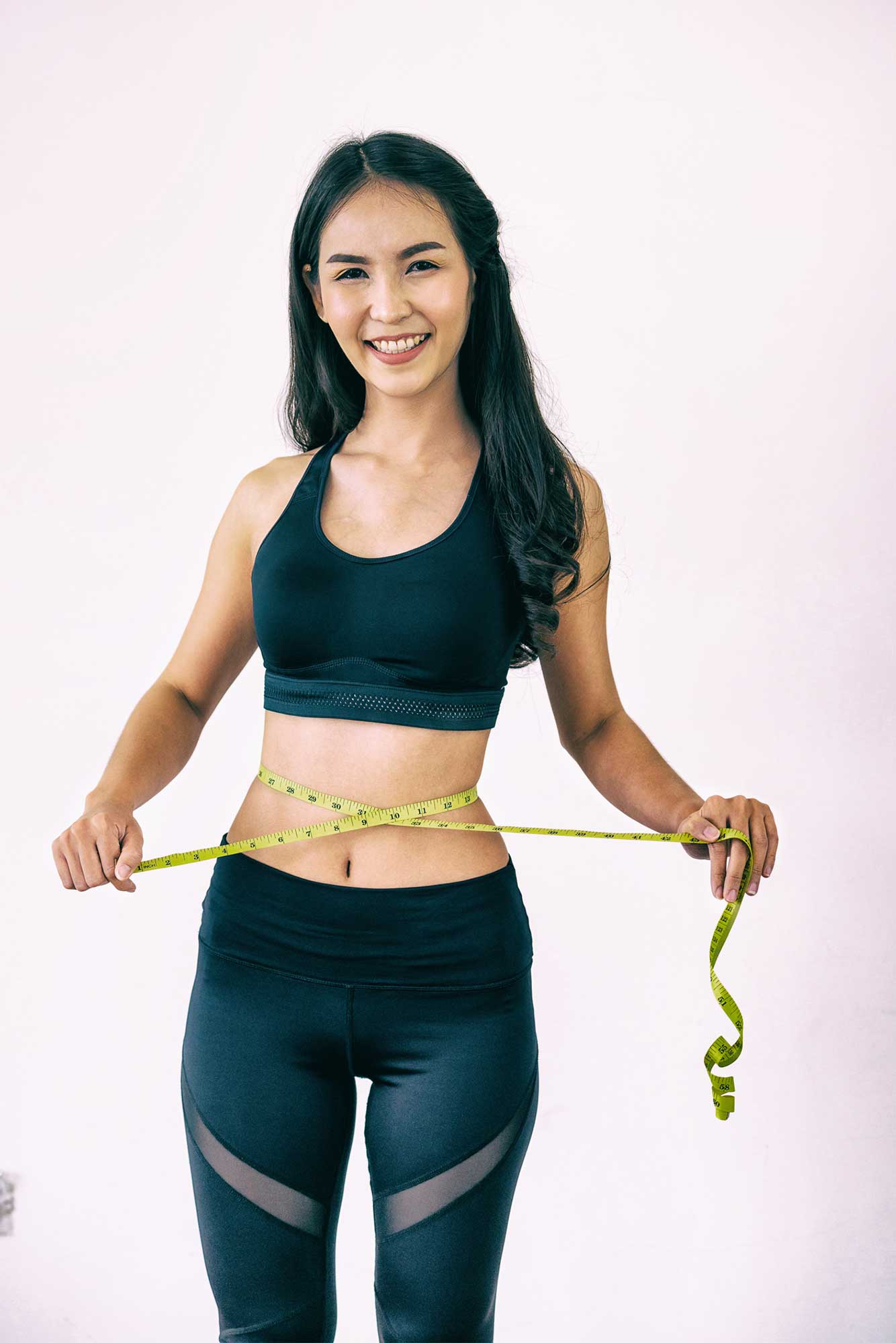 Woman with Slim Body Measuring Her Waistline — Hampton, VA — Doctors Weight Loss Clinic