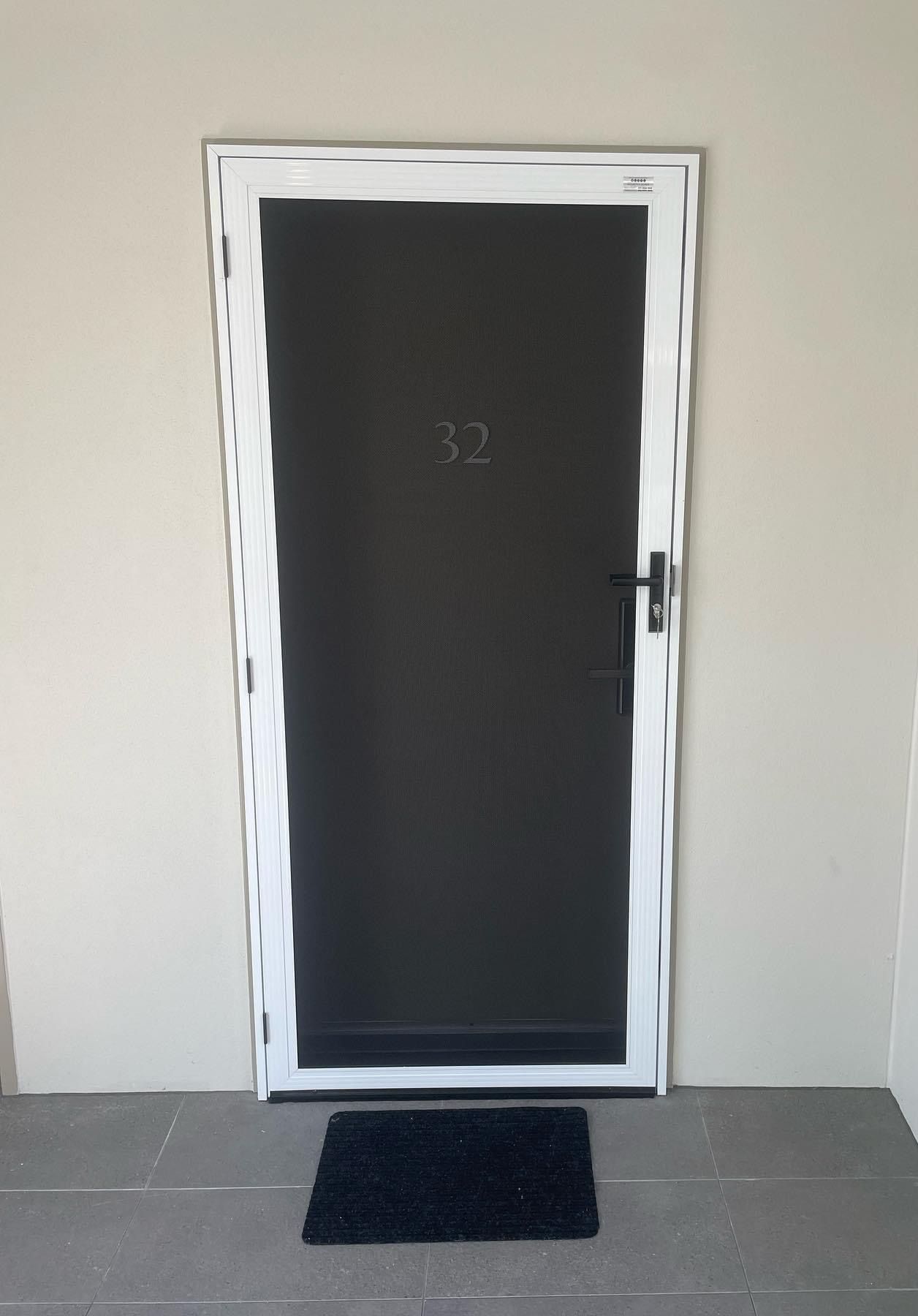 Black Door With Number 32 Sign —  Tweed Coast Security & Blinds in Bogangar, NSW