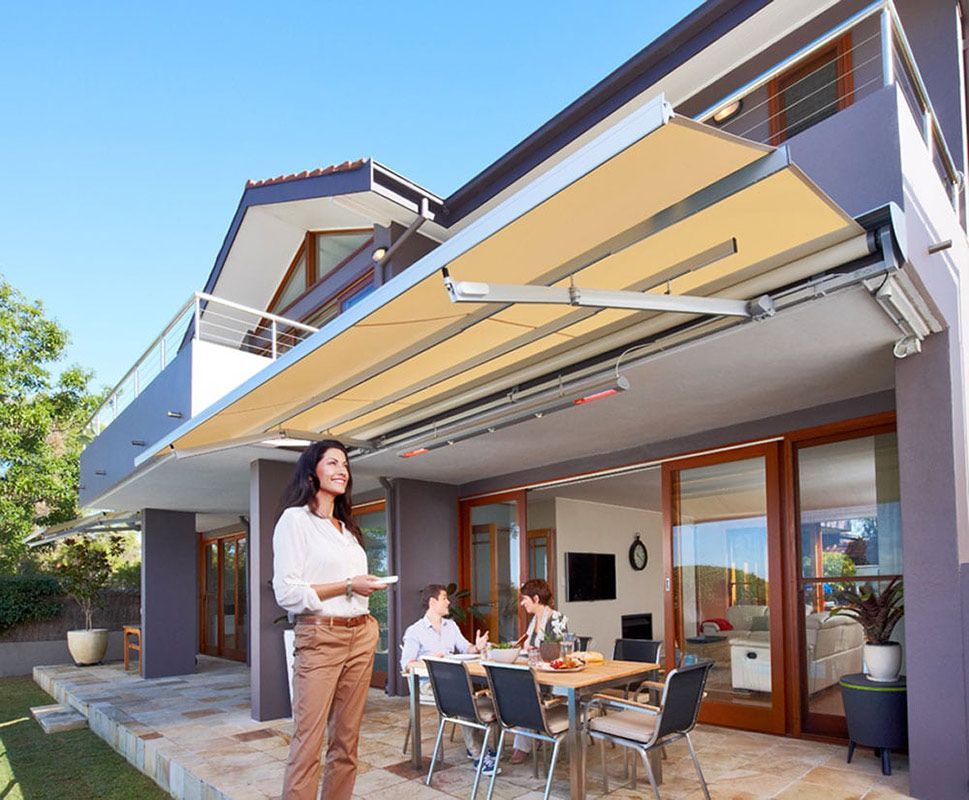 Motorised Folding Arm Awning Over Backyard Setting — Blinds in Bogangar, NSW