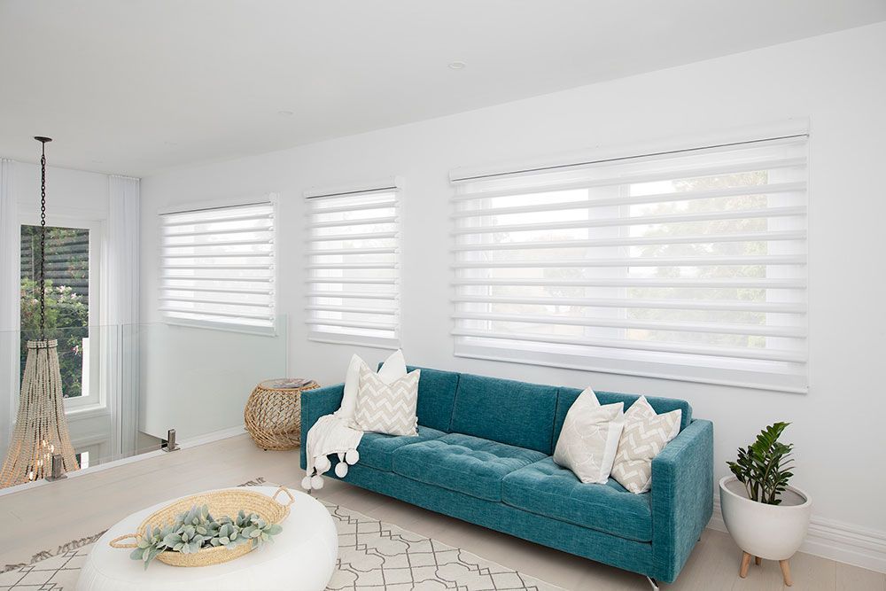 Pirouette Blinds White Blinds Behind Teal Couch — Blinds in Bogangar, NSW