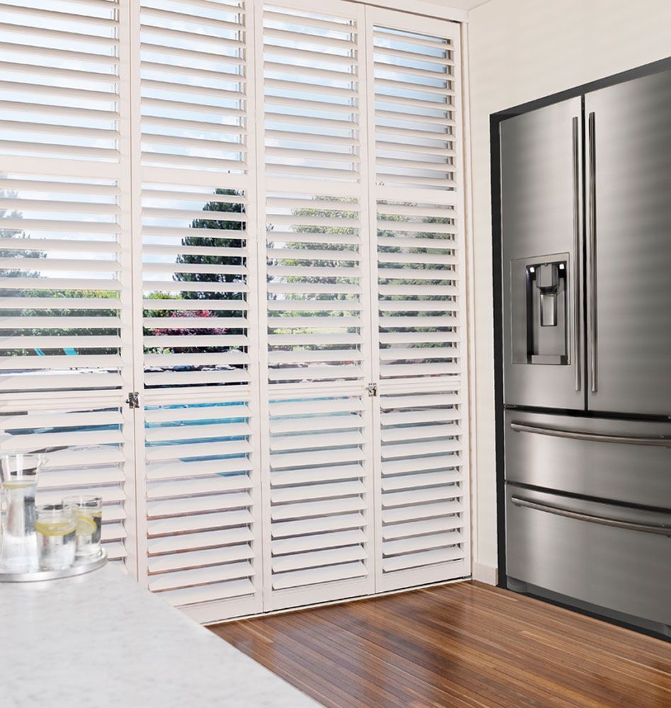 White Aluminium Shutters Enhance Kitchen Ambiance — Blinds in Bogangar, NSW