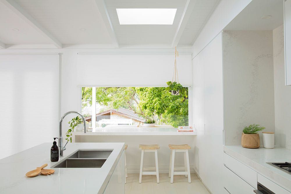 White Duette Shades Enhance Kitchen Ambiance — Blinds in Bogangar, NSW