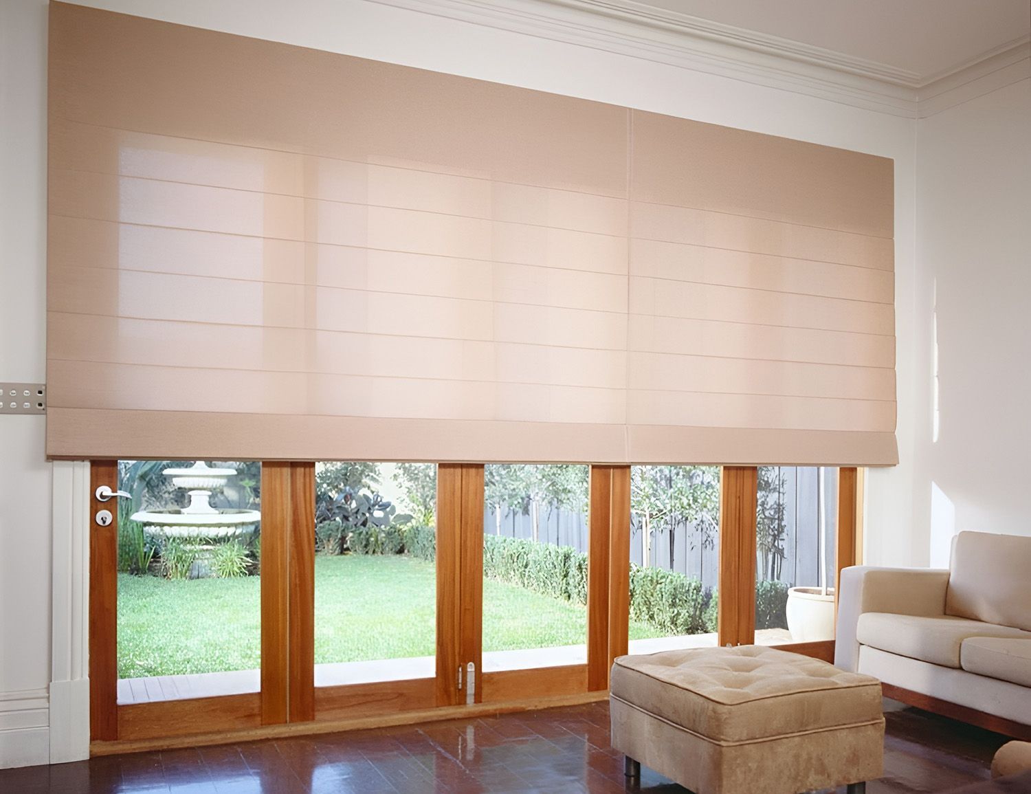 Beige Roller Blinds Over Wooden Doors And Windows