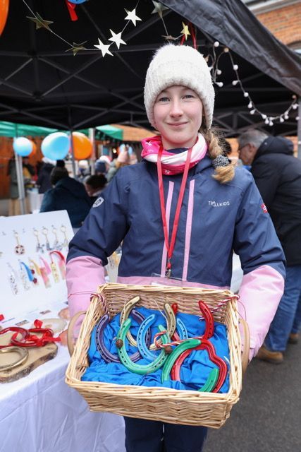 a girl showing painted horseshoes