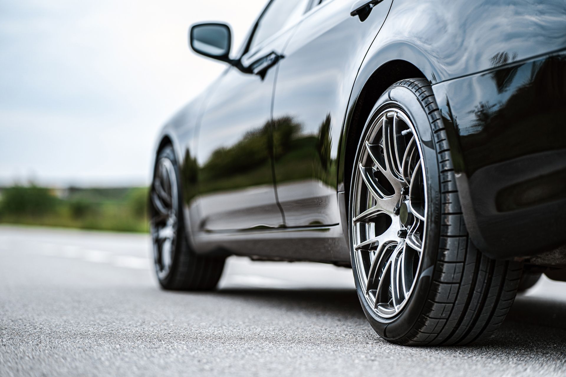 A Black Car is Parked on the Side of the Road