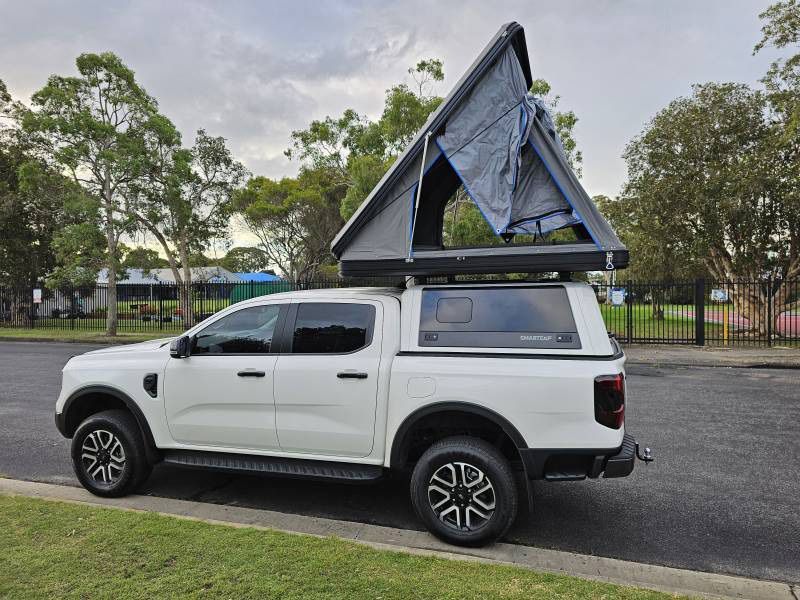 A White Truck With A Tent On Top Of It — A Weigh In - Mobile Weighing Solutions in Noraville, NSW
