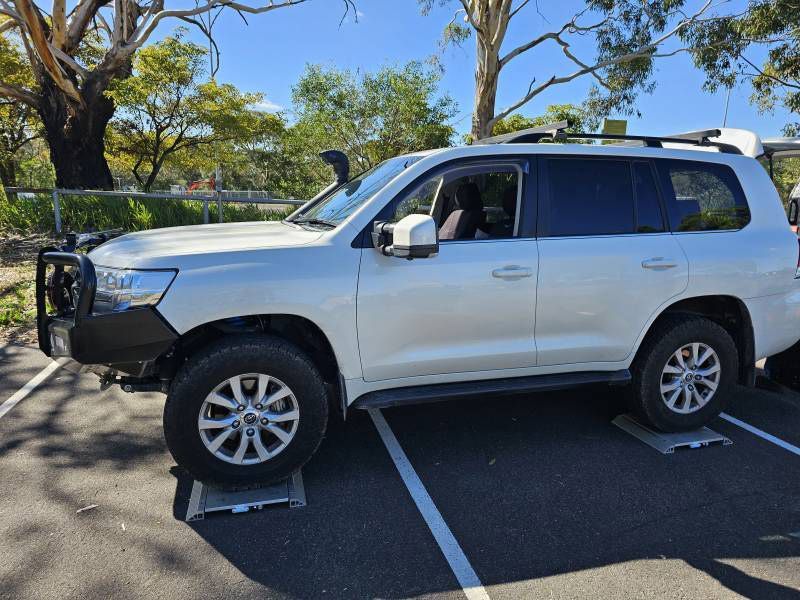 A White SUV Is Parked — A Weigh In - Mobile Weighing Solutions in Noraville, NSW