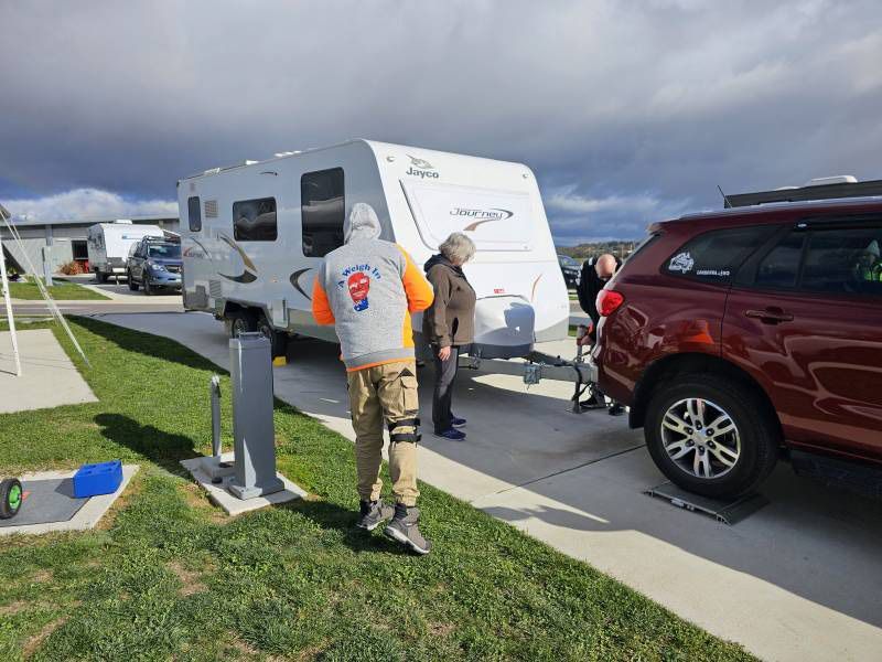 A Man Worker, A Red SUV And White Caravan — A Weigh In - Mobile Weighing Solutions in Noraville, NSW
