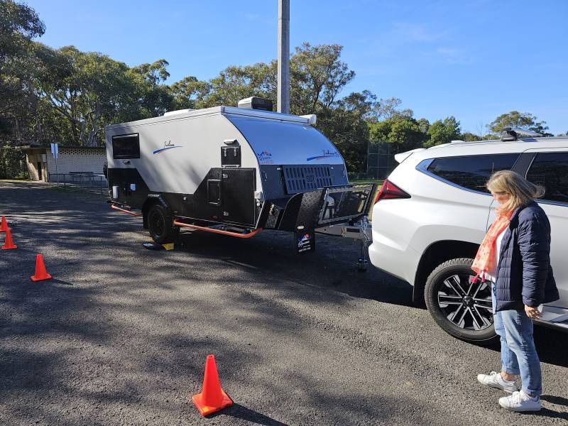 A Woman Is Standing Next To A White SUV — A Weigh In - Mobile Weighing Solutions in Noraville, NSW