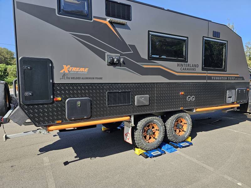 A Black And Orange Camper Trailer — A Weigh In - Mobile Weighing Solutions in Noraville, NSW