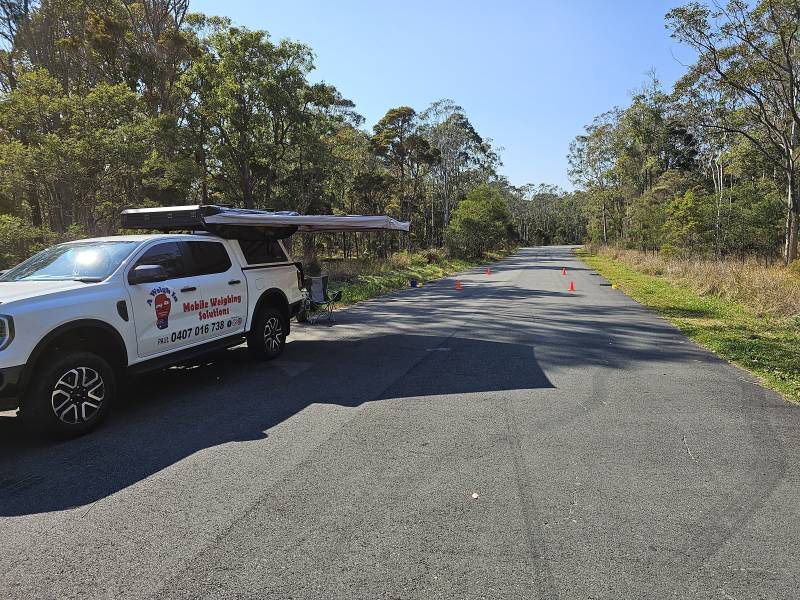 A White Truck Is Parked On The Side Of A Road — A Weigh In - Mobile Weighing Solutions in Noraville, NSW