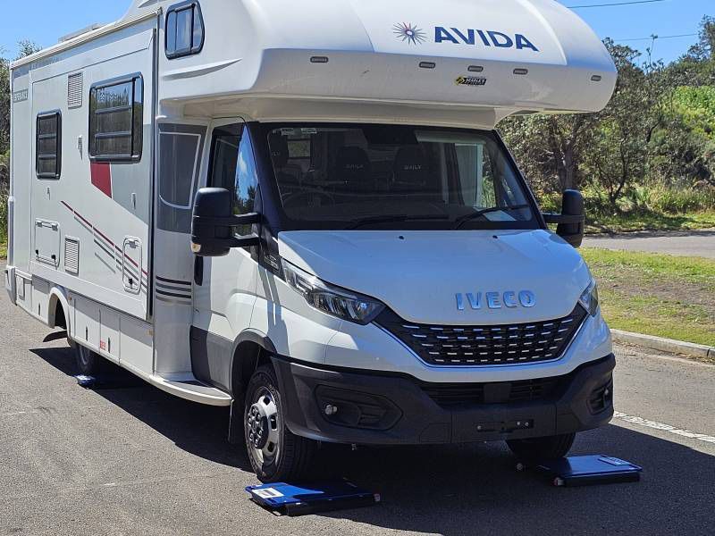A White Camper Van With The Wod Iveco On The Front — A Weigh In - Mobile Weighing Solutions in Noraville, NSW