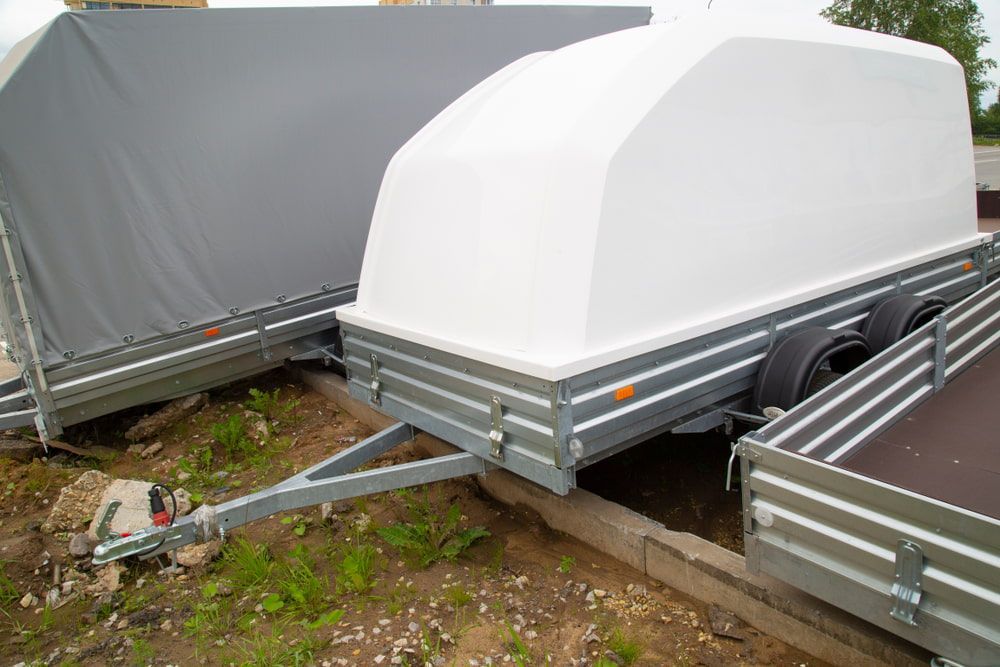 Two Trailers Are Parked Next to Each Other on A Dirt Road — A Weigh In - Mobile Weighing Solutions in Newcastle, NSW