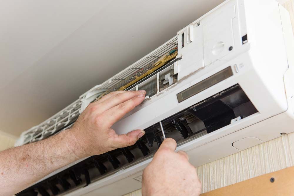 Man Troubleshooting An Air Conditioner