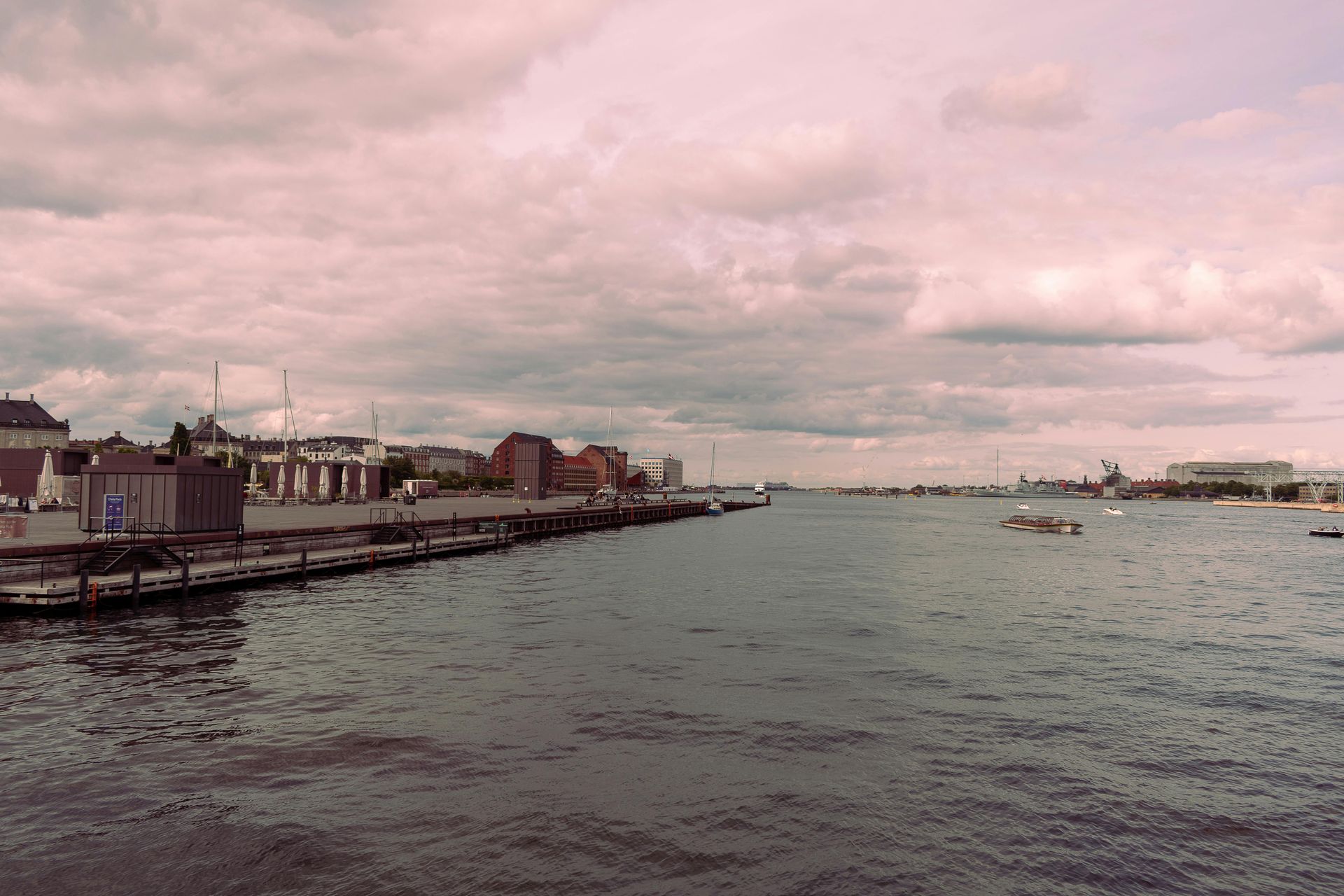 Southampton. Harbour view with cloudy sky and buildings along the water's edge. Some boats are in the water.
