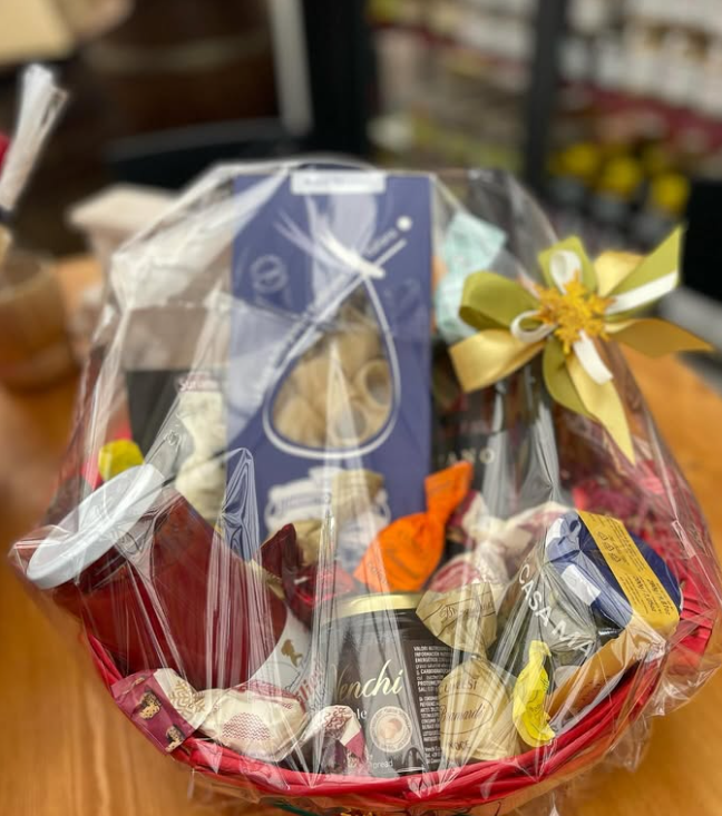 Un cesto rosso pieno di una varietà di prodotti alimentari