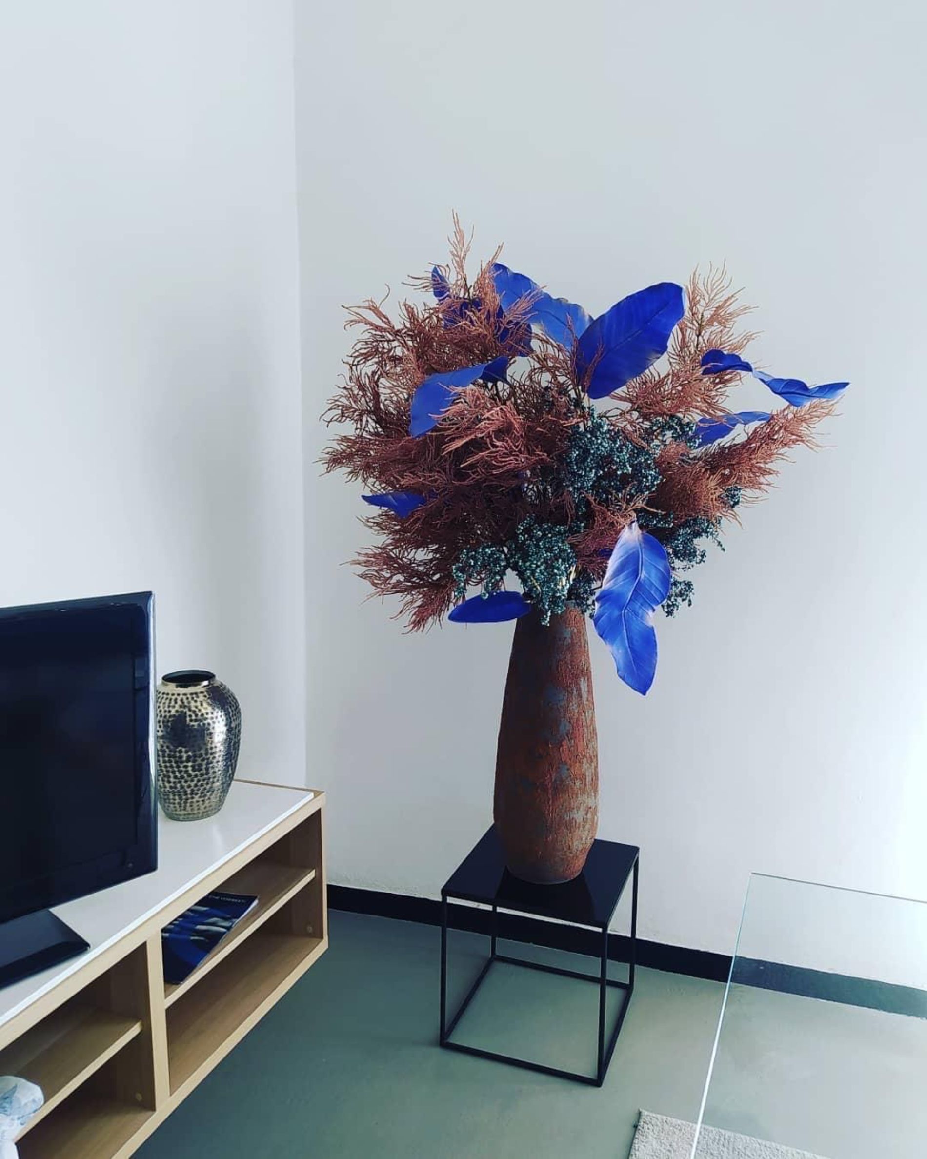 composizione floreale con foglie blu  Fiorista Rischi La Spezia