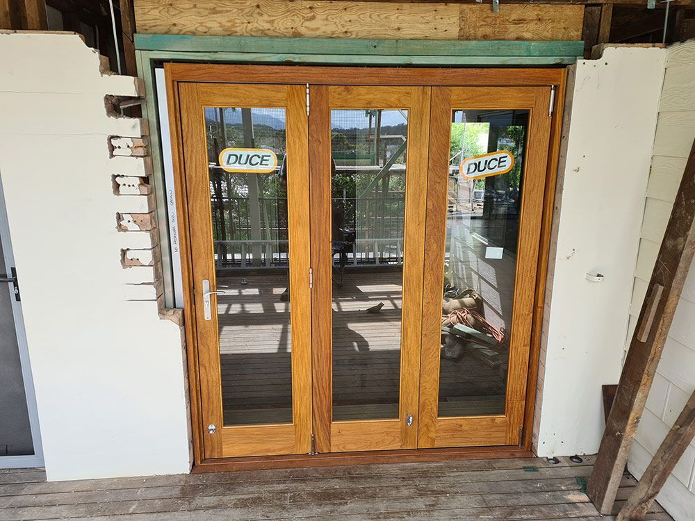 A Wooden Door With A Sign That Says Grace On It — Coffs Coast Building Pty Ltd in Toormina, NSW