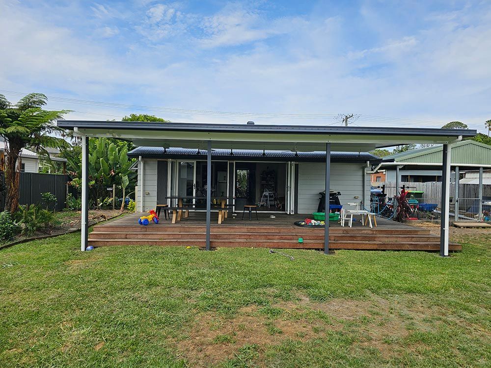 A House With A Deck And A Covered Porch In The Backyard — Coffs Coast Building Pty Ltd in Toormina, NSW